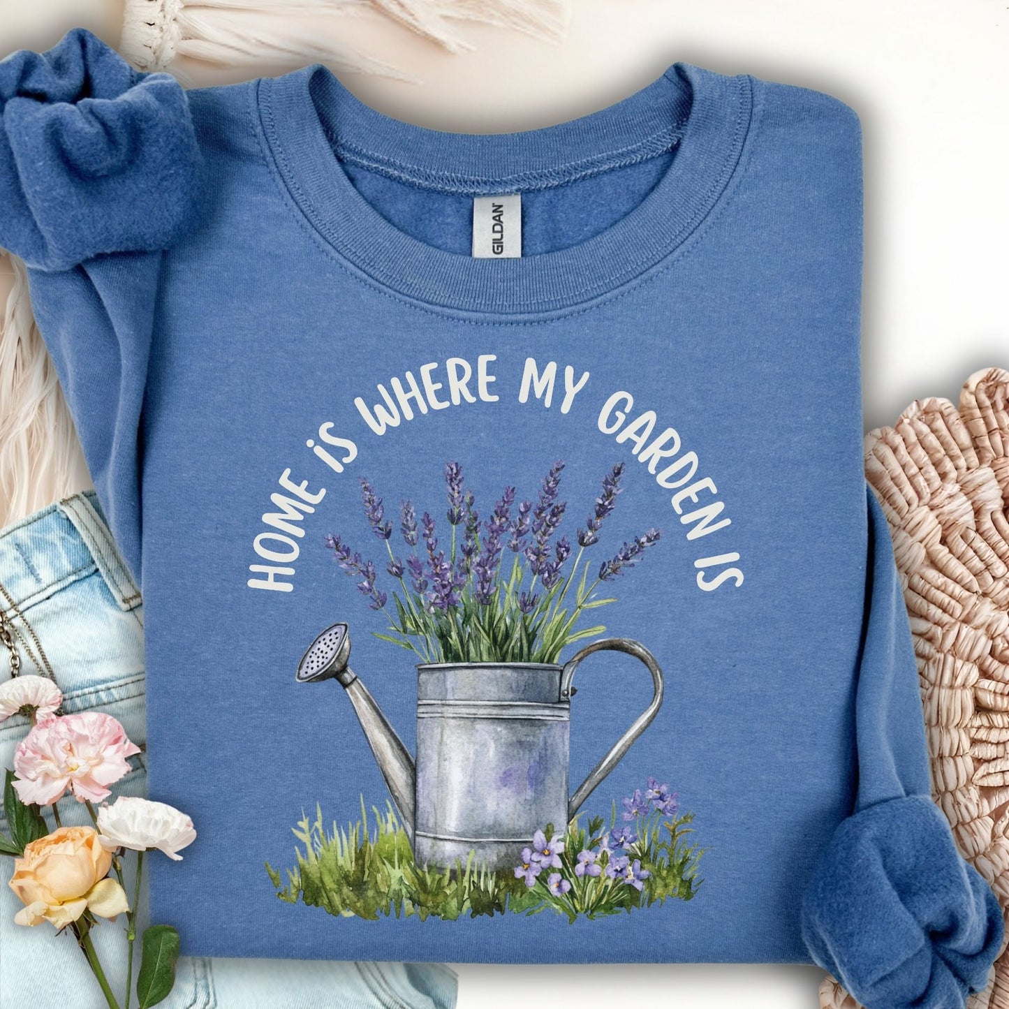 Indigo blue sweatshirt with "Home is where my garden is" text and a watercolor watering can with lavender.