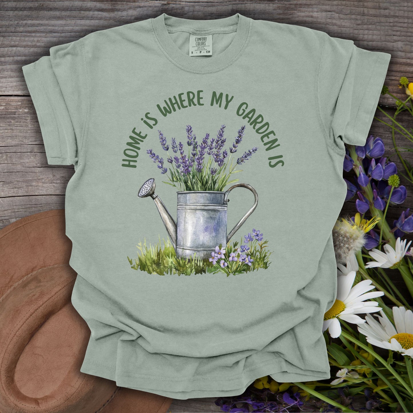 Bay S t-shirt with a watercolor watering can overflowing with lavender and "Home Is Where My Garden Is" text.