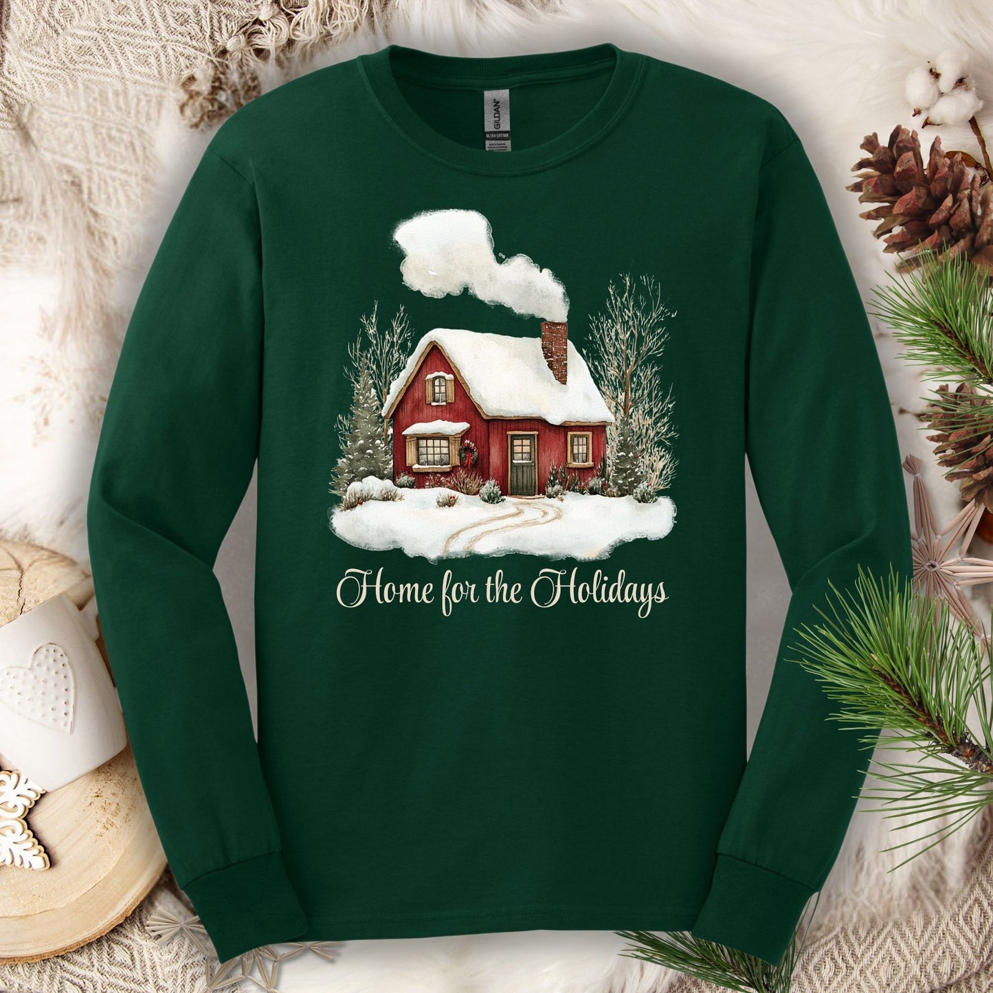 Forest Green Gildan Softstyle long sleeve tee with watercolor red cabin, evergreens, and "Home for the Holidays" script.
