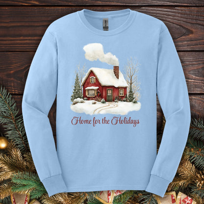 Light blue Gildan long sleeve tee with a watercolor red cabin, evergreens, and "Home for the Holidays" script.
