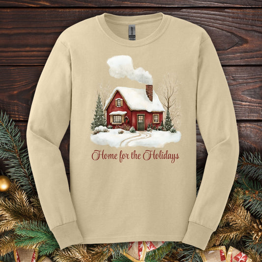 Sand Gildan Softstyle long sleeve tee with watercolor red cabin, evergreens, and "Home for the Holidays" script.