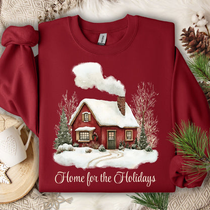 Cardinal Red Gildan fleece sweatshirt with vintage watercolor snowy cabin and "Home for the Holidays" text.