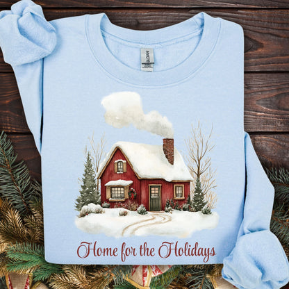 Light blue Gildan fleece sweatshirt with vintage watercolor red cabin and "Home for the Holidays" text.