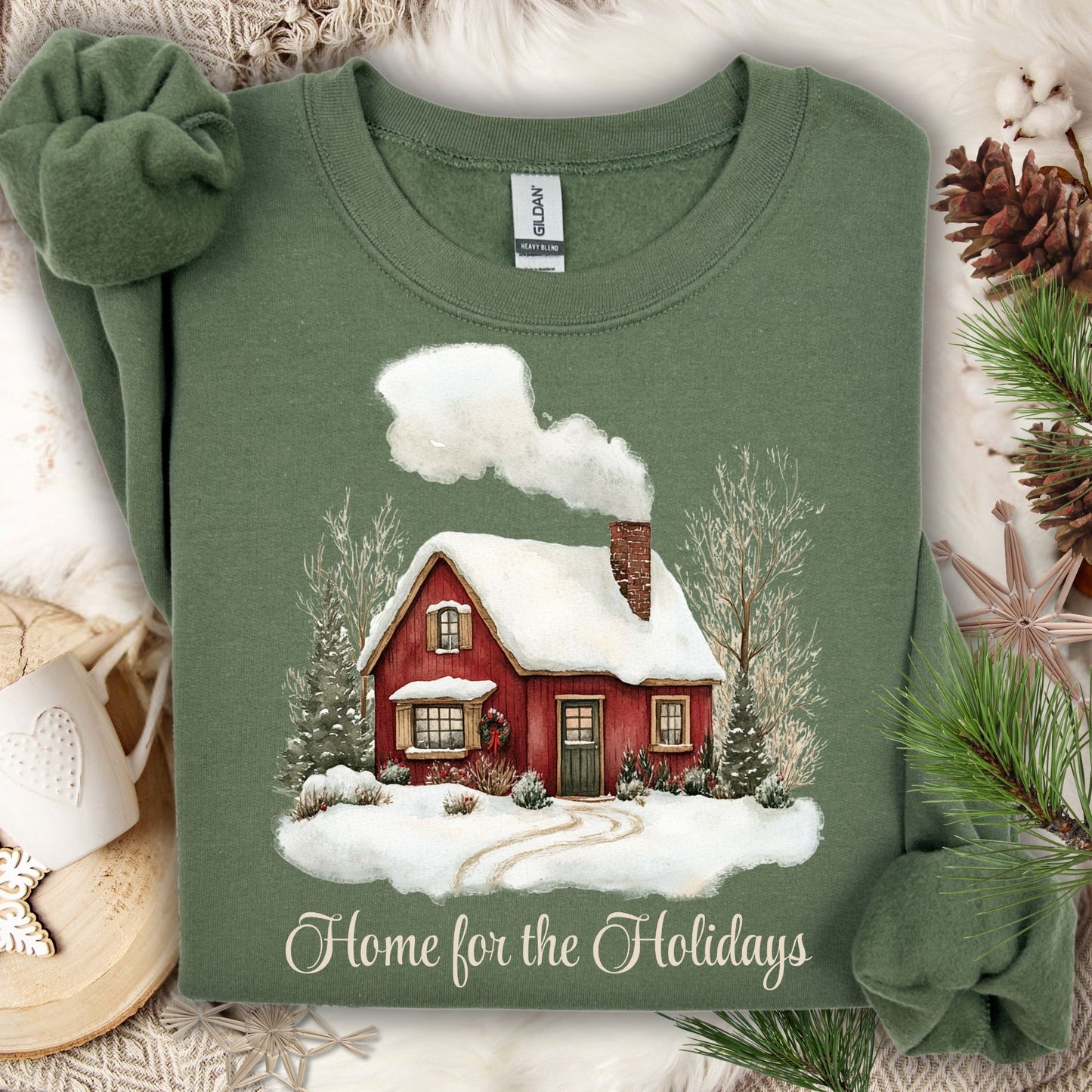 Military Green Gildan sweatshirt with vintage watercolor red cabin and "Home for the Holidays" text.