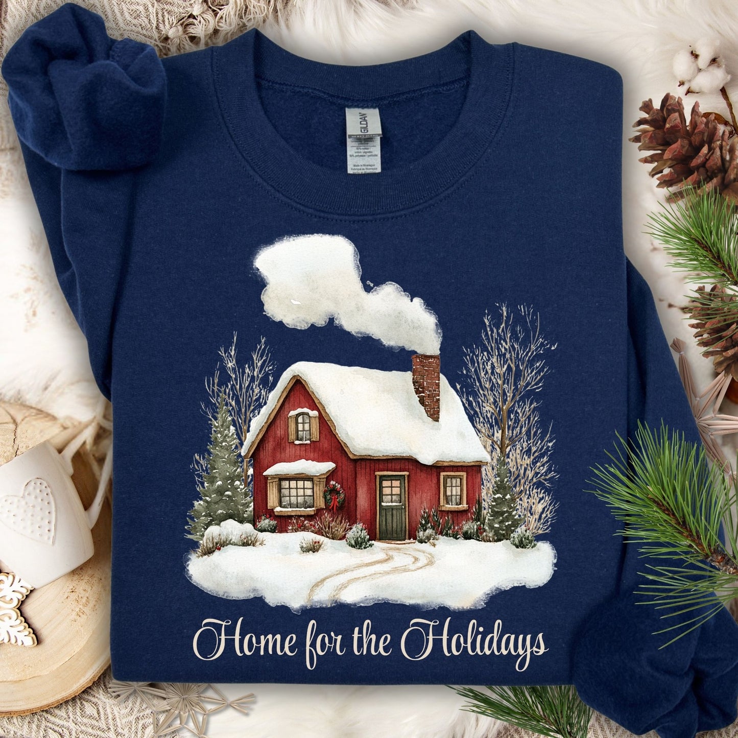 Navy Gildan fleece sweatshirt with vintage watercolor red cabin and "Home for the Holidays" text.