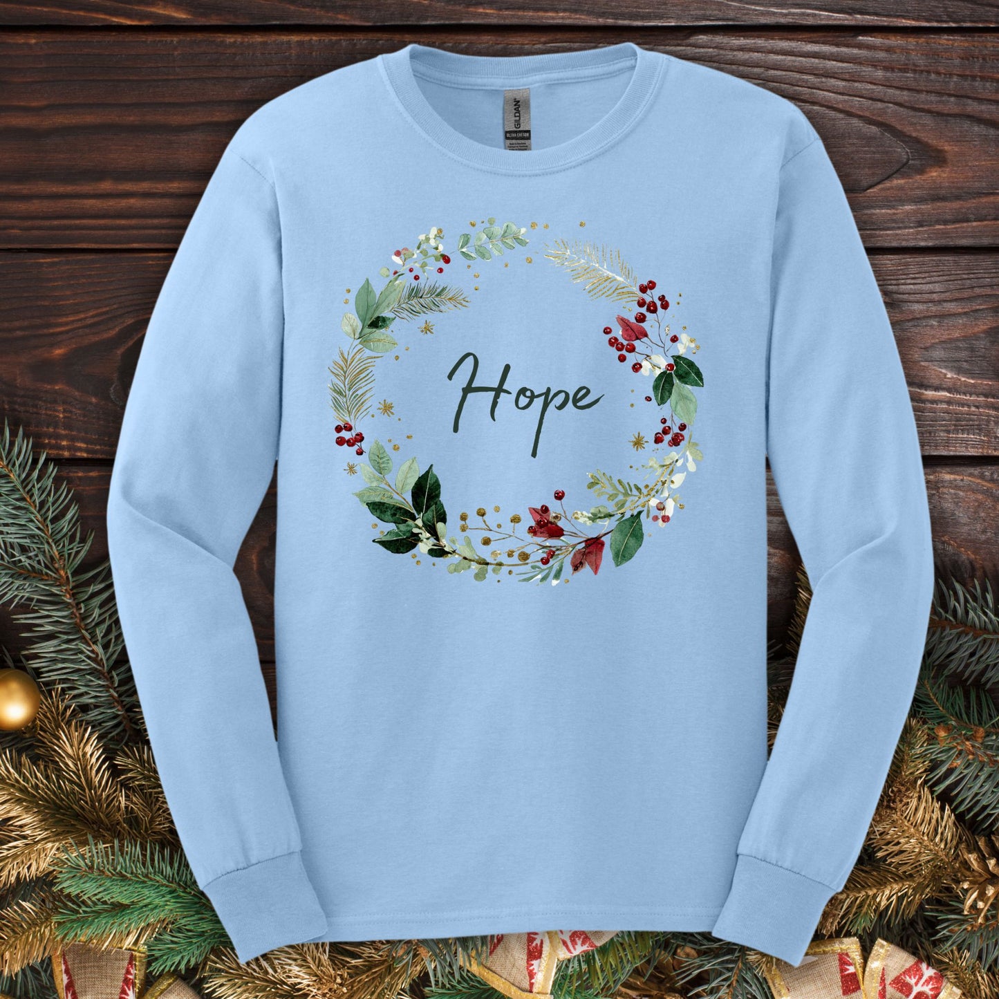 Light blue long sleeve tee with a watercolor "Hope" Christmas wreath design.