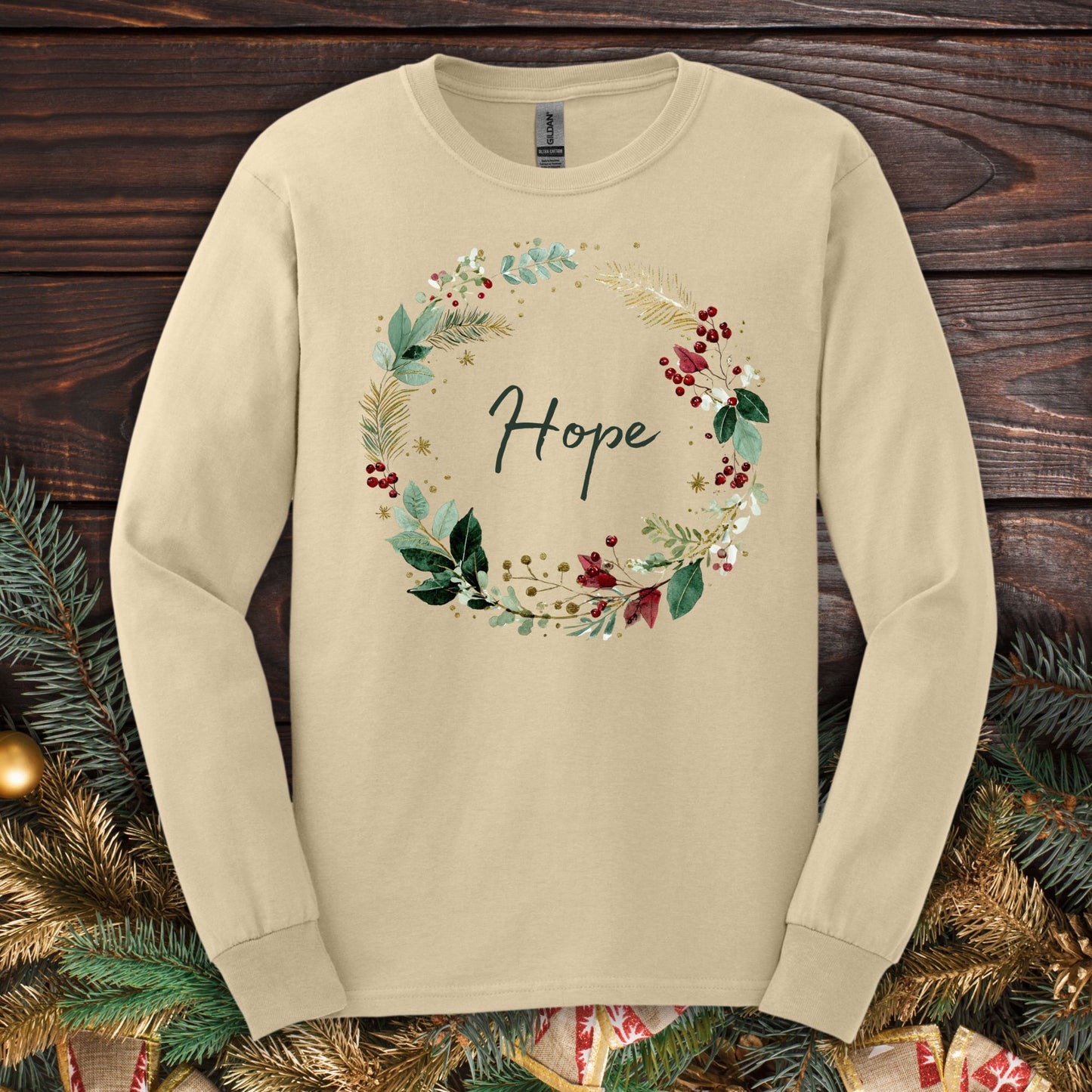 Sand long sleeve tee with watercolor Christmas wreath and "Hope" in center.