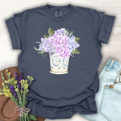 Denim S t-shirt with a watercolor-style hydrangea bouquet in a vintage ceramic vase.