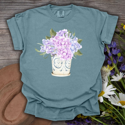 Ice Blue S-size garment-dyed cotton t-shirt with a watercolor hydrangea bouquet in a vintage vase.