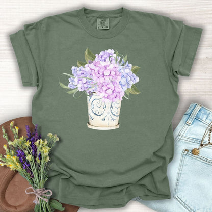 Moss green garment-dyed cotton t-shirt with a watercolor hydrangea bouquet in a vintage vase.