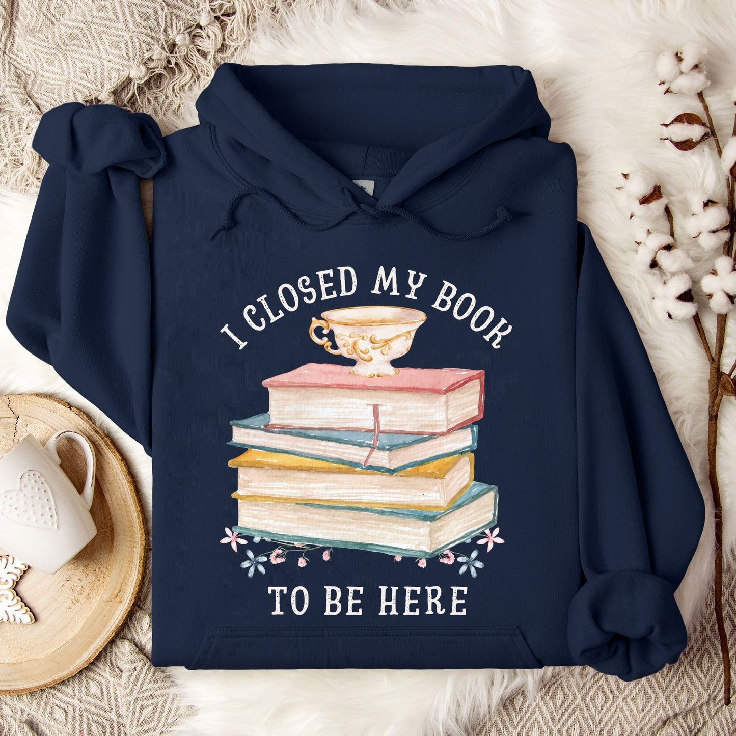 Navy Gildan 18500 hoodie with "I Closed My Book To Be Here" text and stacked books design.
