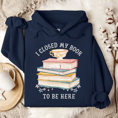 Navy Gildan 18500 hoodie with "I Closed My Book To Be Here" text and stacked books design.
