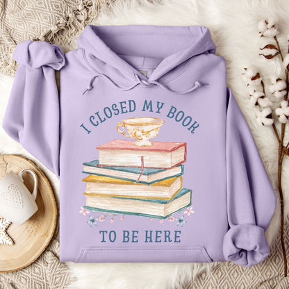 Orchid purple Gildan 18500 hoodie with "I Closed My Book To Be Here" text, stacked books, and teacup graphic.