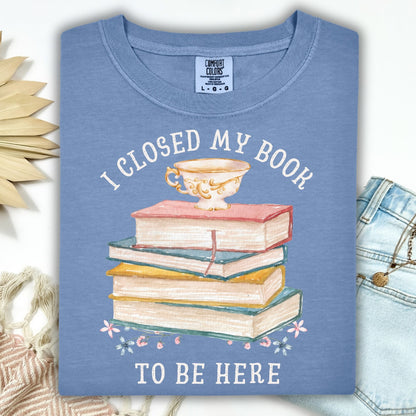 Blue Jean Comfort Colors t-shirt with "I Closed My Book To Be Here" text, watercolor books, teacup, and florals.