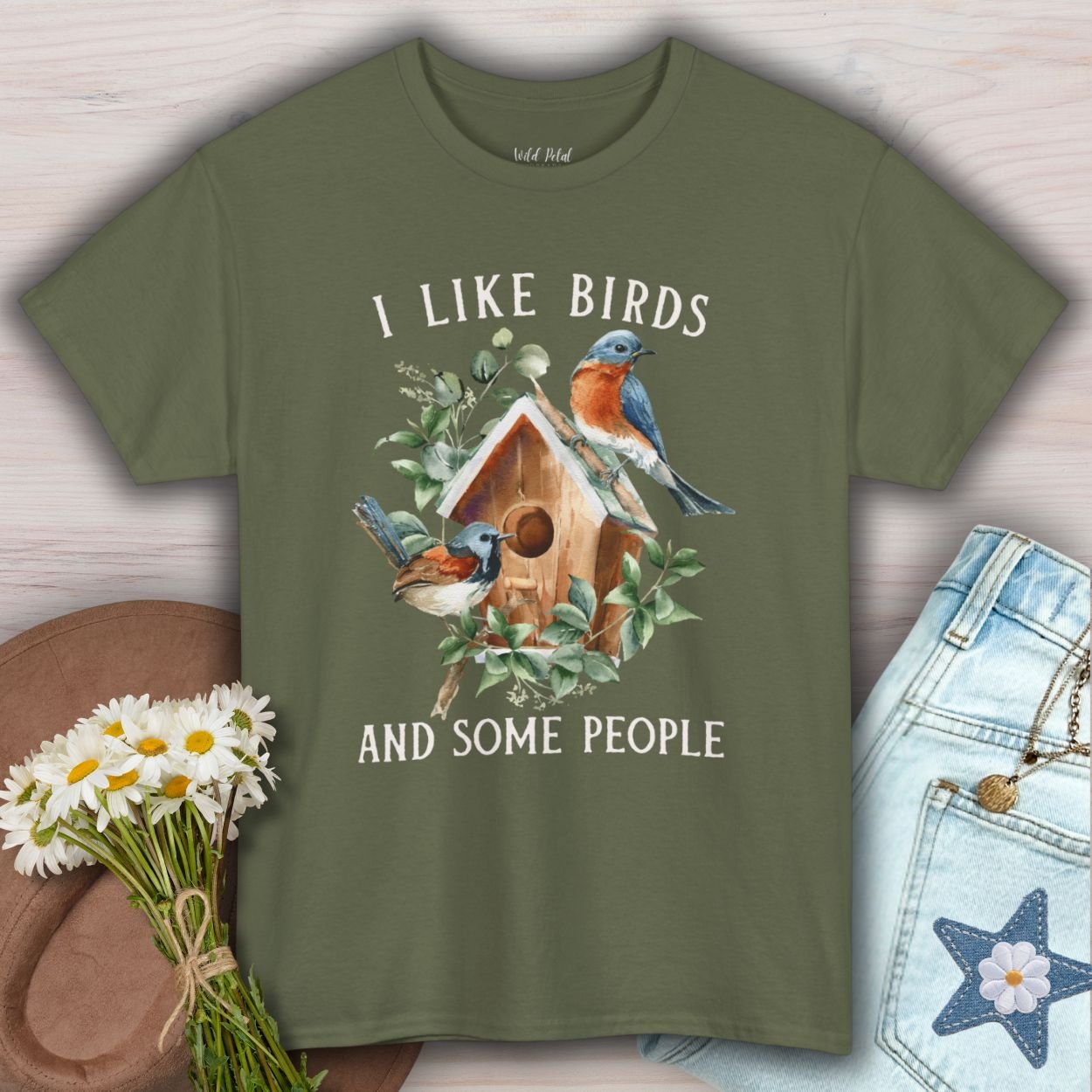 Military Green S t-shirt with "I like birds and some people" text and watercolor bluebirds on a birdhouse.