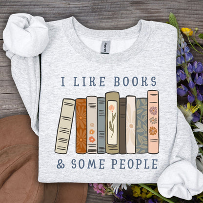 Ash Gildan crewneck sweatshirt with "I like books & some people" and vintage book graphic.