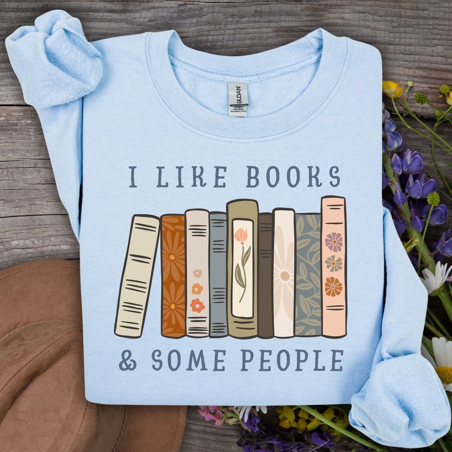 Light blue Gildan crewneck sweatshirt with "I like books & some people" and a row of vintage books graphic.
