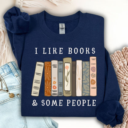 Navy Gildan crewneck sweatshirt with "I like books & some people" and a row of vintage books graphic.