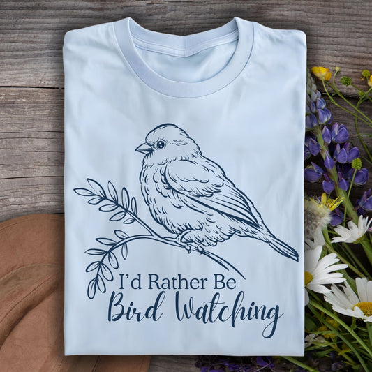 Light blue "I'd Rather Be Birdwatching" t-shirt with a detailed bird on a branch graphic.