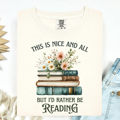 Ivory Comfort Colors t-shirt with "This is nice and all but I'd rather be reading" above a stack of vintage books and wildflowers.