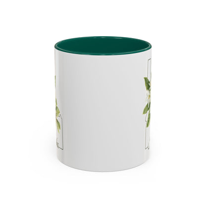 White ceramic mug with a green interior and handle, featuring a delicate Syringa flower illustration within the Idaho state silhouette.