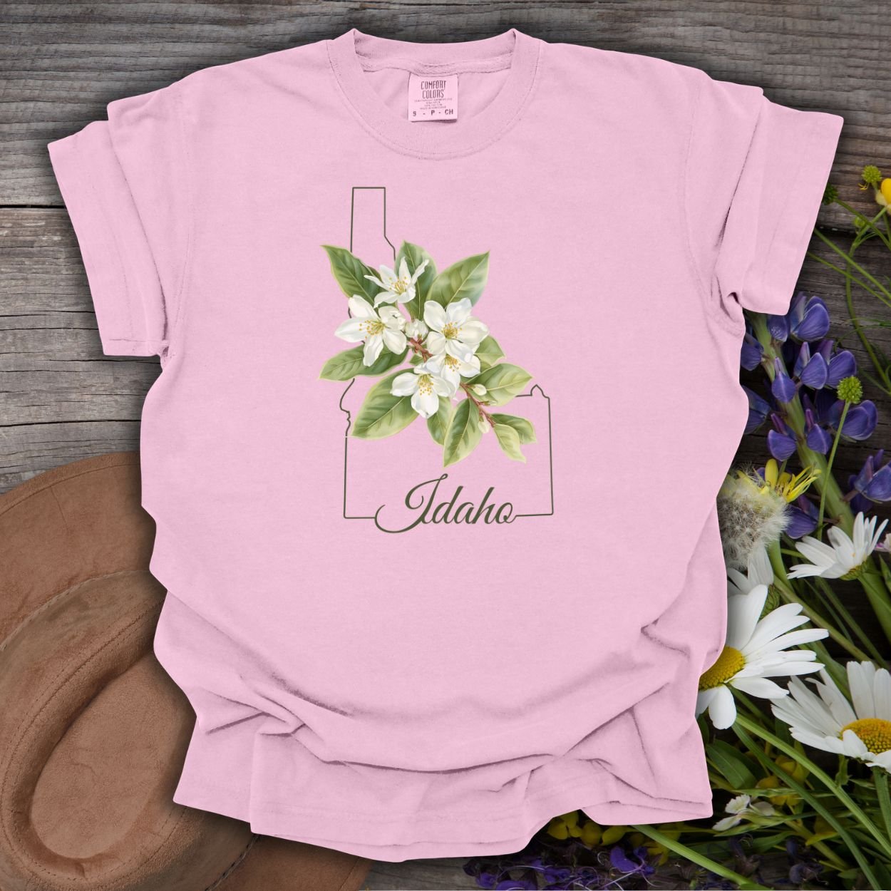 Pink garment-dyed cotton t-shirt with Idaho outline, syringa blossoms, and "Idaho" script.