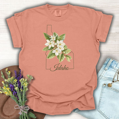 Terracotta S t-shirt with Idaho outline, white syringa blossoms, and "Idaho" script.