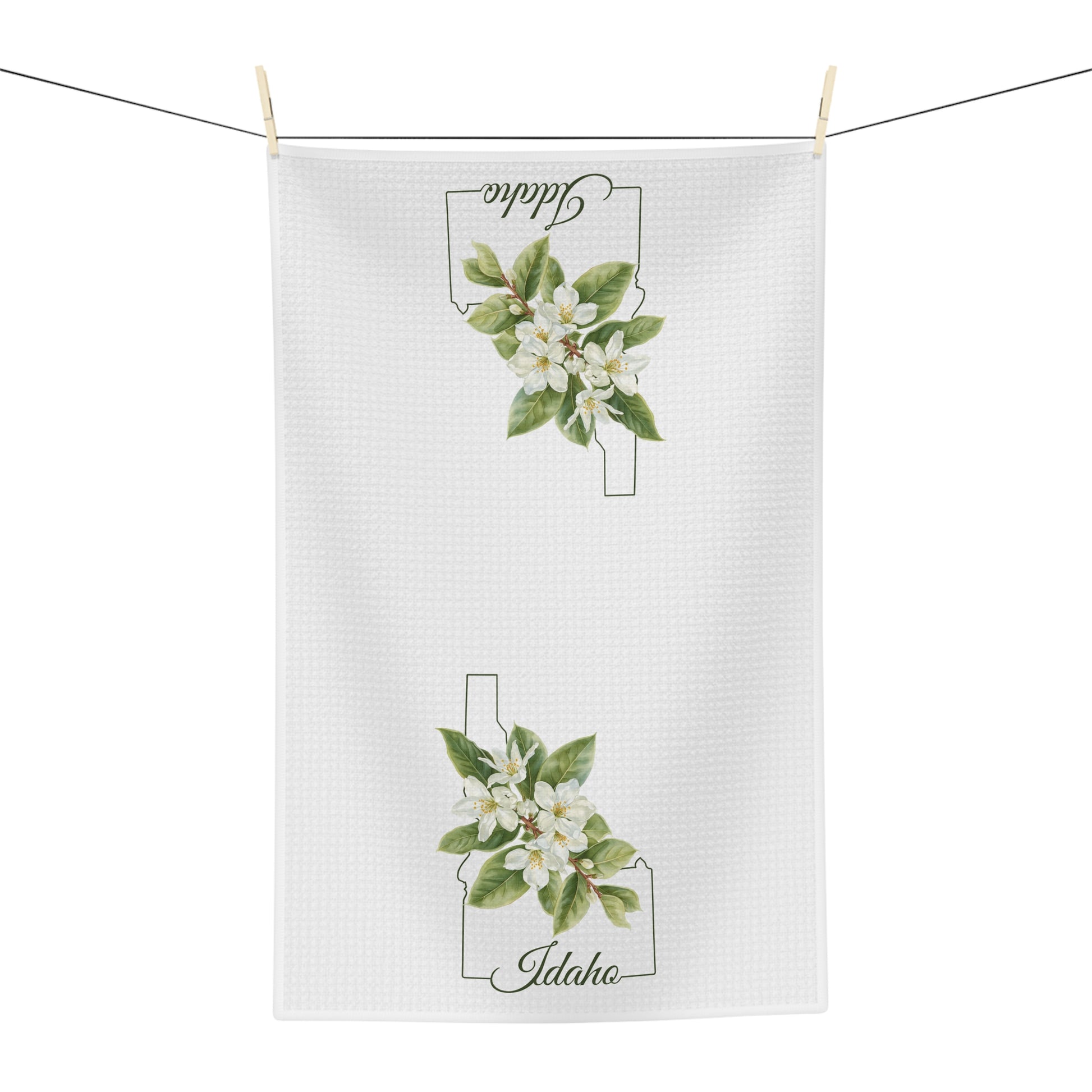 White microfiber tea towel with Idaho state outline and Syringa (mock orange) blossoms.
