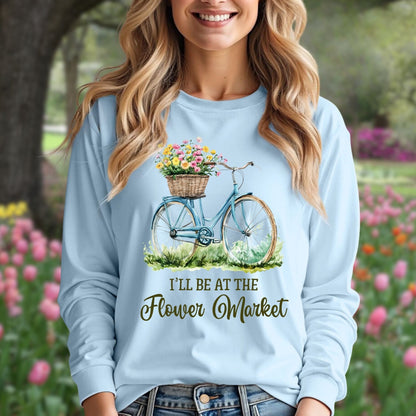 Light blue long sleeve tee with a vintage bicycle and flower basket graphic, "I'll Be At The Flower Market" text.