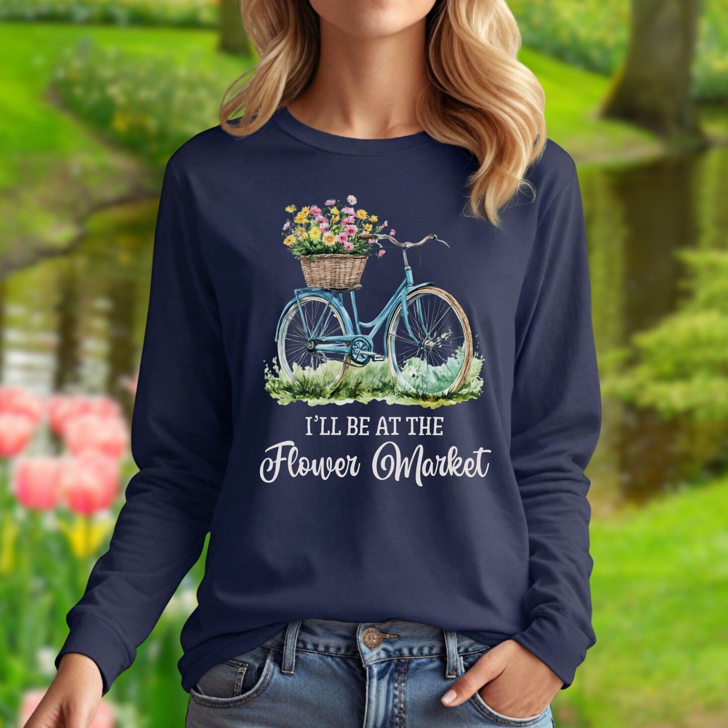 Navy long sleeve tee with a vintage bicycle and pastel flower basket graphic, "I'll Be At The Flower Market" text.