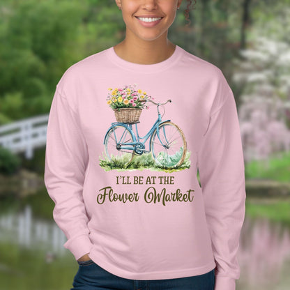 Pink long sleeve tee with a vintage blue bicycle, flower basket, and "I'll Be At The Flower Market" text.