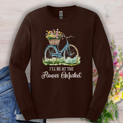 Dark chocolate long sleeve tee with a vintage bicycle, flower basket, and "I'll Be At The Flower Market" text.