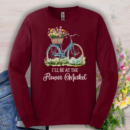 Maroon long-sleeve cotton tee with a vintage blue bicycle and flower basket graphic, "I'll Be At The Flower Market" text.