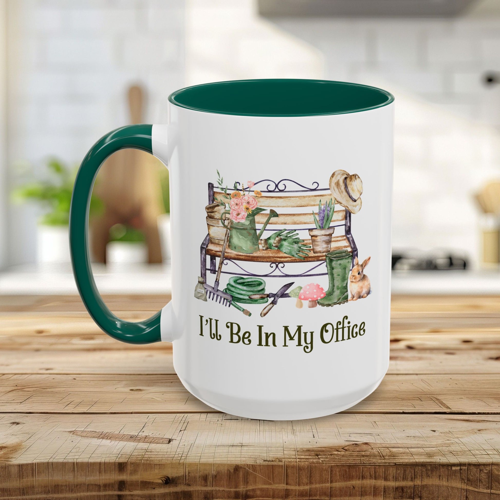 White ceramic gardener mug with green handle and interior, featuring "I'll Be In My Office" and garden tools.