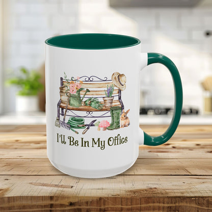 White 15oz ceramic gardener mug with green interior/handle, featuring "I'll Be In My Office" and watercolor garden tools.