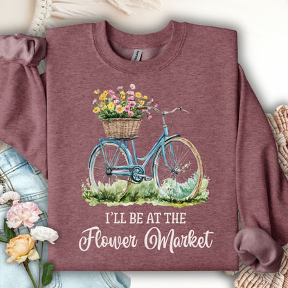 Heather Sport Dark Maroon sweatshirt with a blue bicycle, flower basket, and "I'll Be At The Flower Market" text.