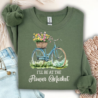 Military Green "I'll Be at the Flower Market" crewneck sweatshirt with a blue bicycle and flower basket graphic.