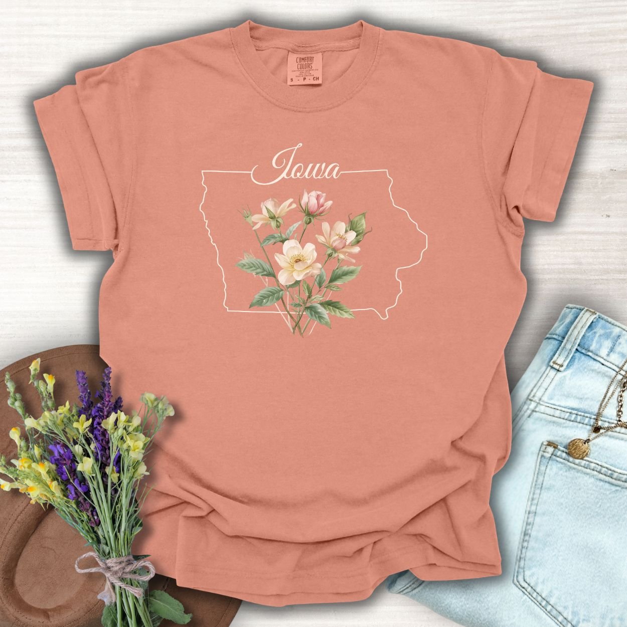 Terracotta S t-shirt with Iowa outline, handwritten name, and wild prairie rose bouquet.