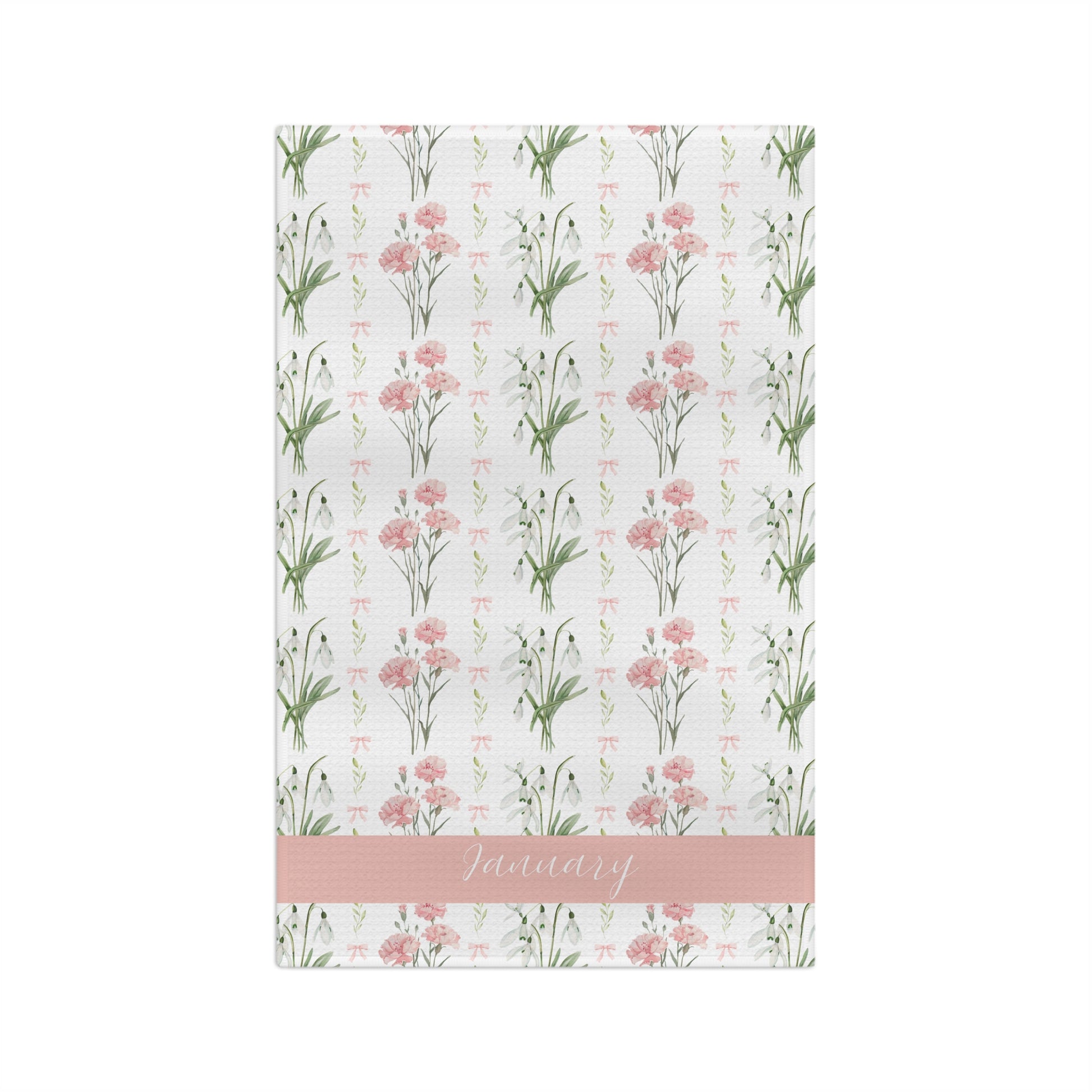 White microfiber tea towel with watercolor pink carnations, snowdrops, and "January" on a pink band.