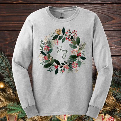 Ash gray Gildan long sleeve tee with a watercolor Christmas wreath and "Joy" in the center.