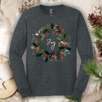 Dark Heather Gildan long sleeve tee with a watercolor Christmas wreath and "Joy" in the center.