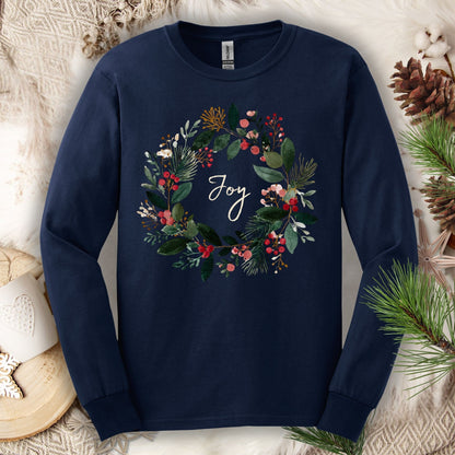 Navy Gildan long sleeve tee with a watercolor Christmas wreath and "Joy" in the center.