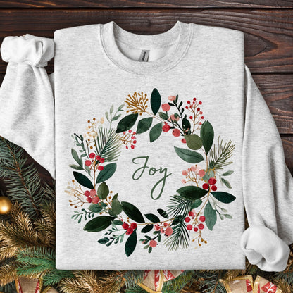 Ash Gildan crewneck sweatshirt with a watercolor Christmas wreath and "Joy" in the center.
