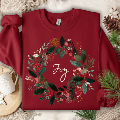 Cardinal Red Gildan crewneck sweatshirt with a watercolor Christmas wreath and "Joy" in the center.