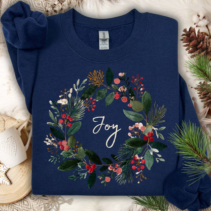 Navy Gildan crewneck sweatshirt with a watercolor Christmas wreath and "Joy" in the center.