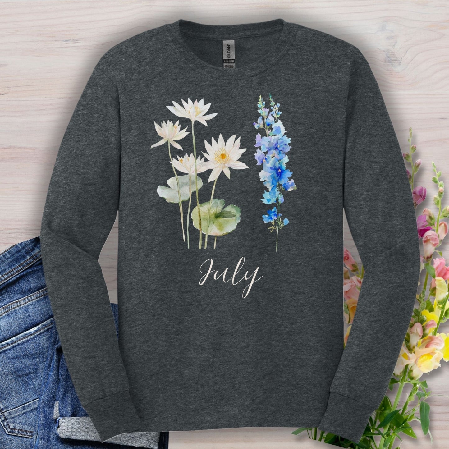 Dark heather long-sleeve tee with watercolor waterlily and larkspur, "July" script.