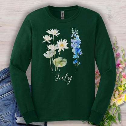Forest green long sleeve tee with watercolor waterlilies, larkspur, and "July" script.
