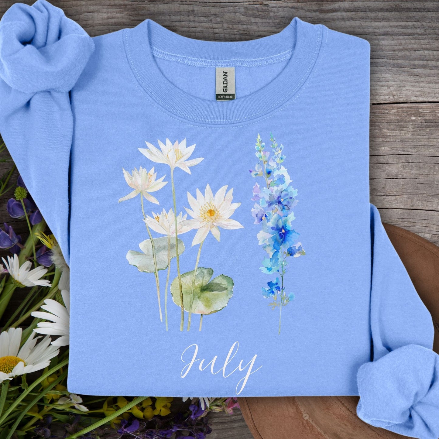 Carolina Blue S sweatshirt with watercolor waterlilies, larkspur, and "July" text.