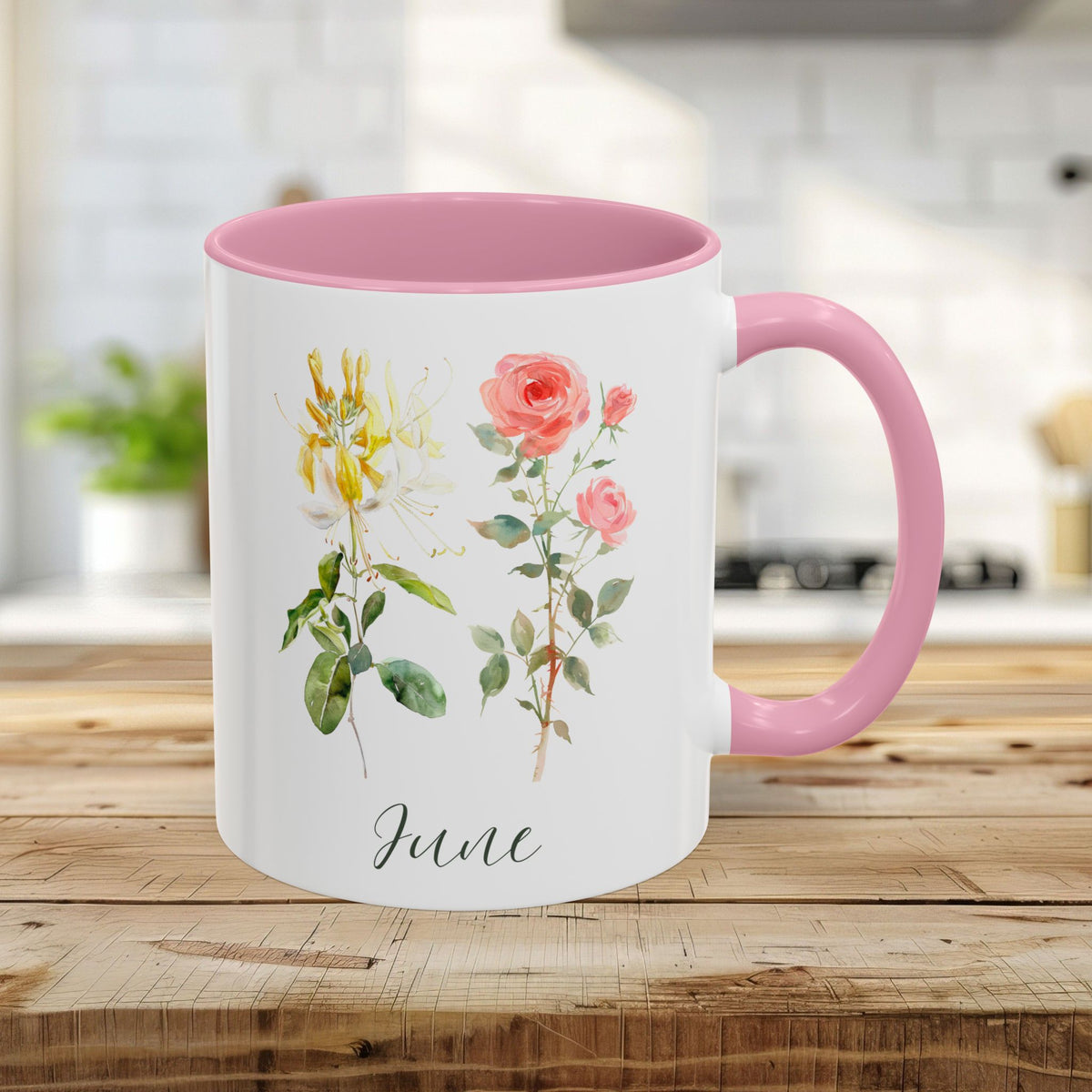 11oz white ceramic mug with pink handle and interior, featuring watercolor honeysuckle, rose, and "June" script.