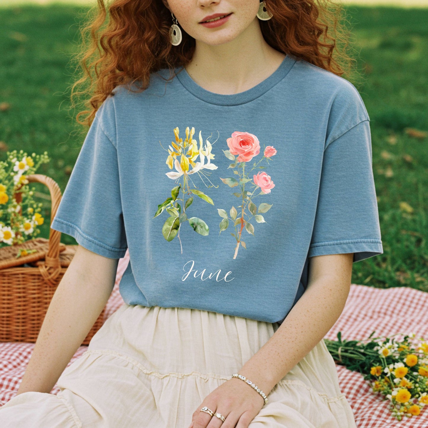 Woman in a relaxed-fit, garment-dyed blue tee with honeysuckle, rose, and "June" watercolor design.